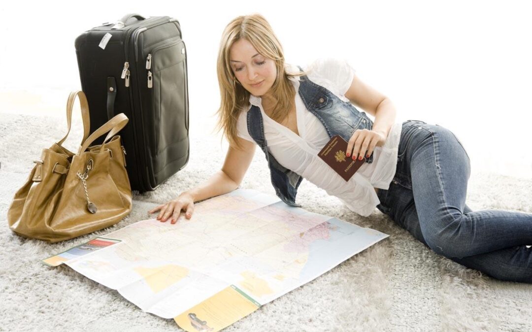A woman sitting on the ground looking at a map